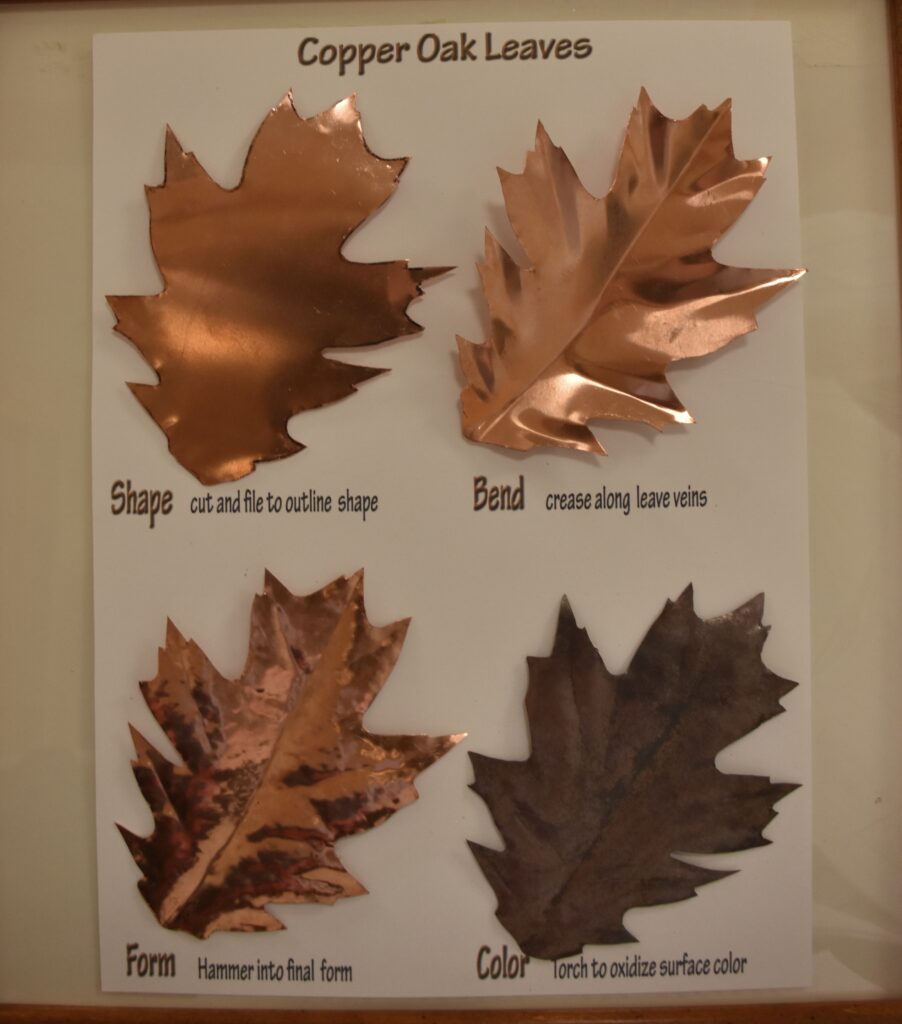 Last year I made a sculpture of different species of leaves copied from live samples of leaves here at Stoneridge.
I decided to use a tracing of one of the oak leaves to create a single copper leaf mounted in a small oak frame for each of our combined siblings and children.  
The four leaves displayed here show the main steps in the leaves' creation.

