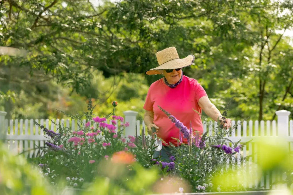 A senior woman gardening in her home at StoneRidge, a life plan community in Mystic, CT.