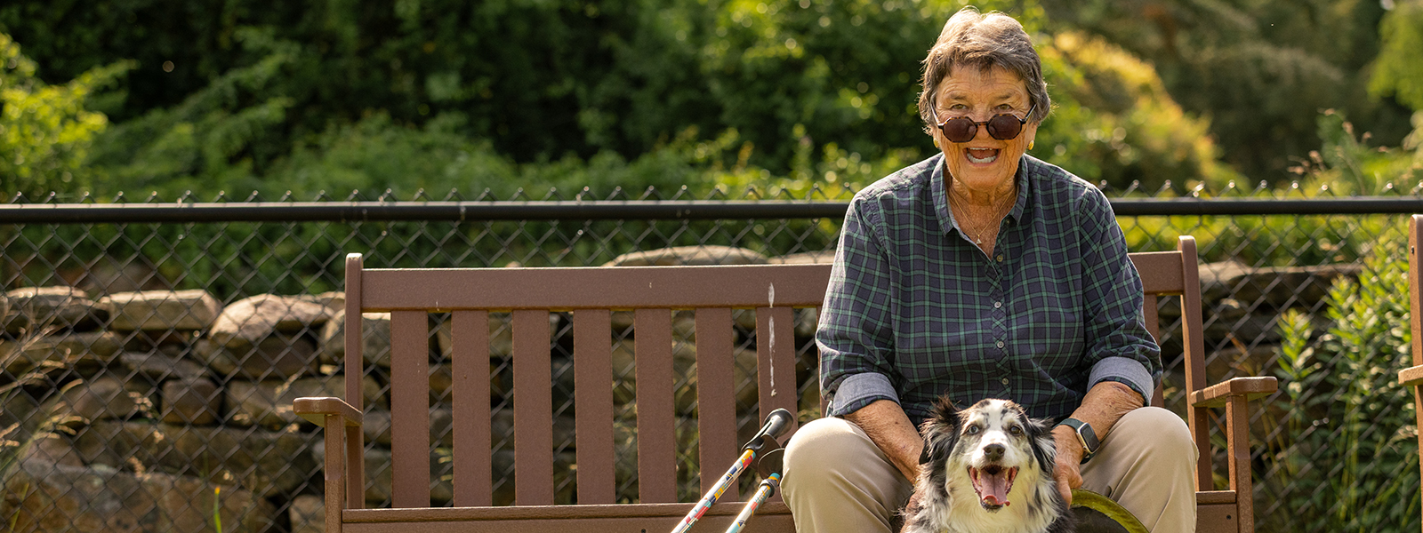senior lady sitting on a bench with her dog