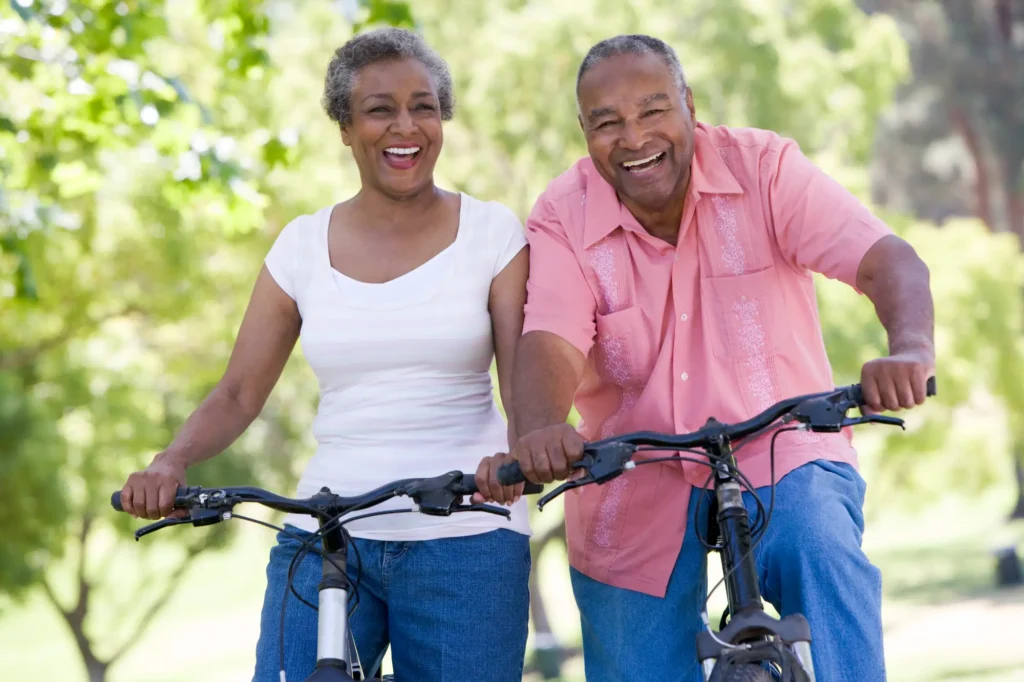 An active senior couple riding bikes on a trail near StoneRidge Senior Living in Mystic, CT.